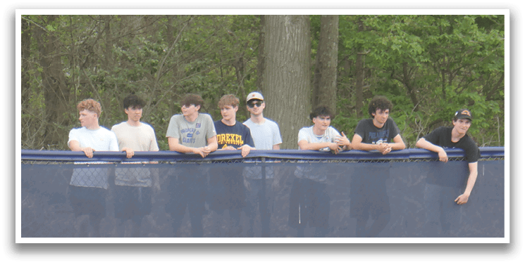 A group of people are standing on a grassy field, watching a baseball game. AI generated content