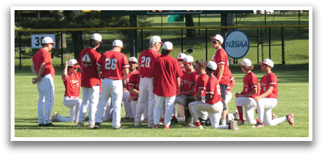 A group of baseball players wearing red and white uniforms are gathered on the field. They are kneeling and facing the same direction, possibly praying before a game. AI generated content