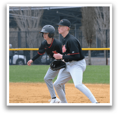 Two baseball players on a field. Description generated by AI