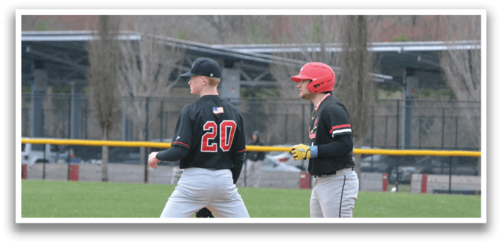 Two baseball players wearing black and red uniforms. Description generated by AI