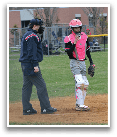 A baseball player wearing a pink helmet. Description generated by AI