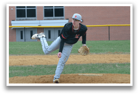 A baseball player in a black shirt and grey pants is pitching a ball. Description generated by AI