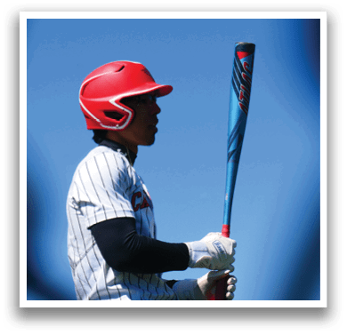 A baseball player holding a bat. Description generated by AI