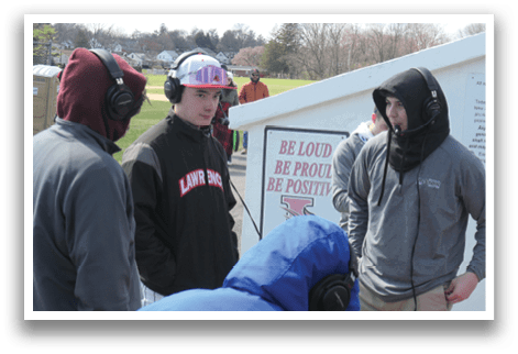 A group of people wearing headphones. Description generated by AI