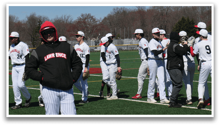 A group of baseball players wearing white uniforms. Description generated by AI