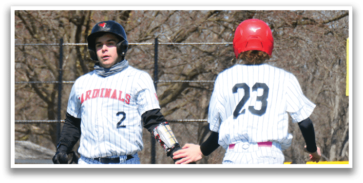 Two baseball players wearing red and white uniforms. Description generated by AI