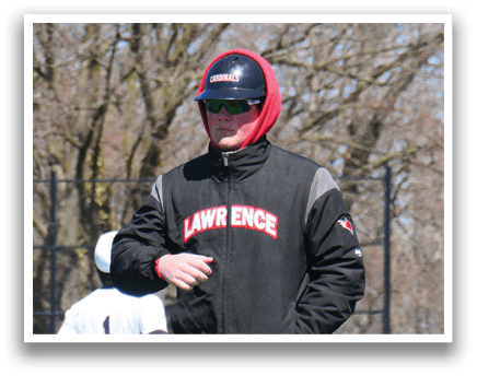 A man wearing a black and red jacket and a red hoodie. Description generated by AI