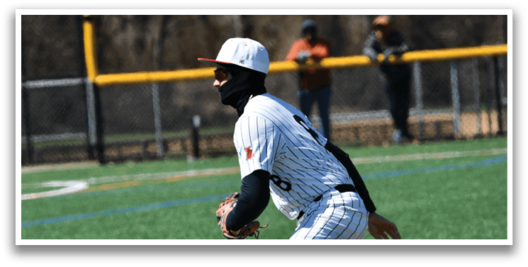 A baseball player wearing a black and white uniform and a red hat. Description generated by AI