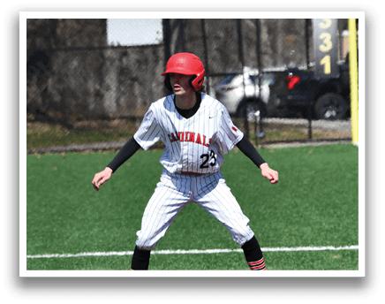 A baseball player wearing a red helmet and white uniform is standing on the field. Description generated by AI