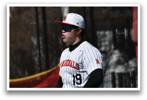 A baseball player wearing a white and black uniform. Description generated by AI