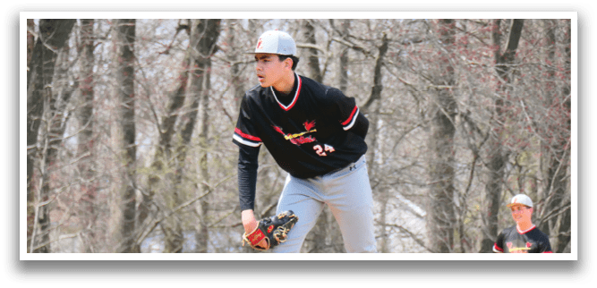 A baseball player in a black shirt and red shoes is swinging a bat. Description generated by AI