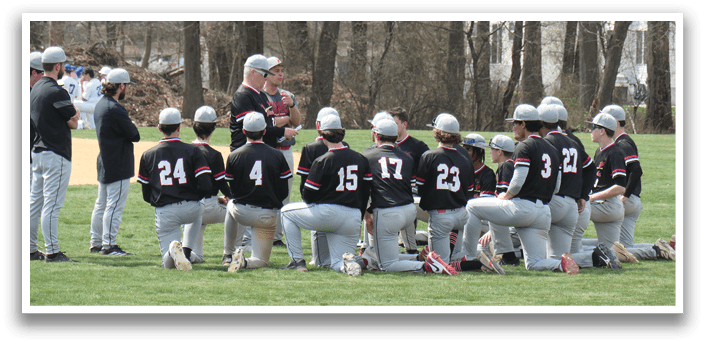 A group of baseball players kneeling on the field. Description generated by AI
