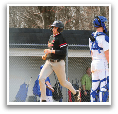 A baseball player wearing a black shirt and grey pants running on the field. Description generated by AI