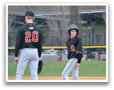 Two baseball players standing on the field. Description generated by AI