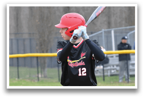 A baseball player in a black and red shirt is swinging a bat. Description generated by AI