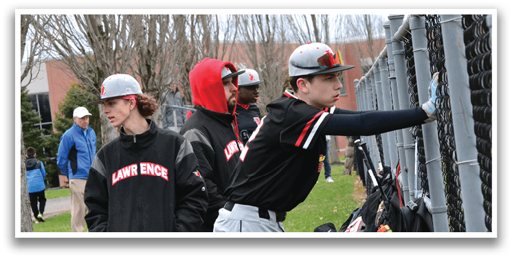 A group of young men wearing black and red hats and jackets. Description generated by AI