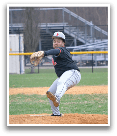A baseball player in a black shirt and white pants is pitching a ball. Description generated by AI