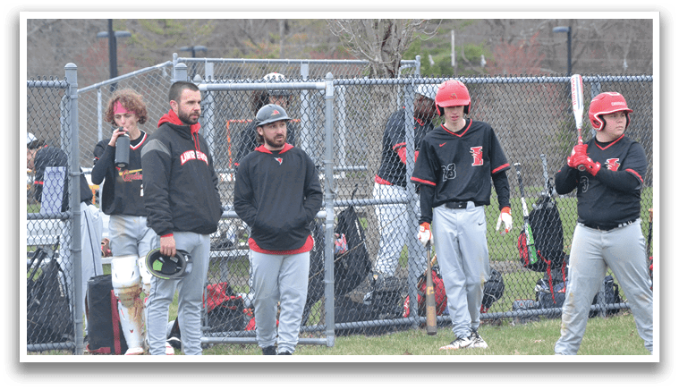 A group of people standing on a baseball field. Description generated by AI