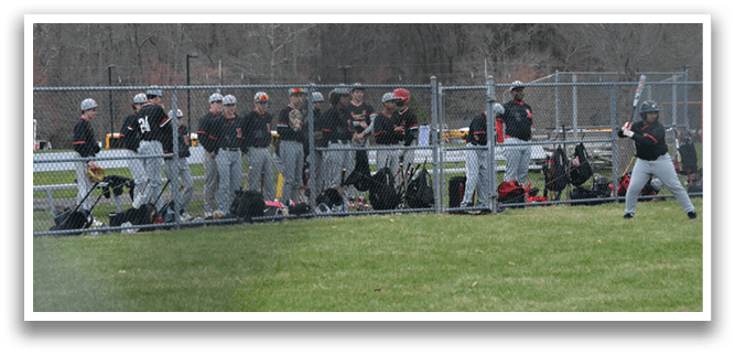Baseball players standing on a field. Description generated by AI