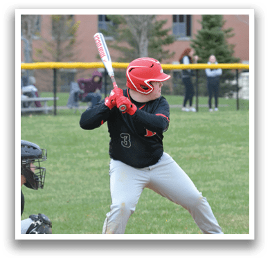 A baseball player in a black shirt and red helmet is swinging a bat. Description generated by AI