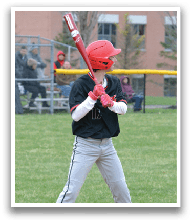A baseball player is swinging a bat on a field. Description generated by AI