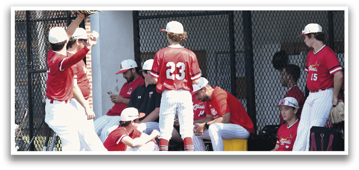 A group of baseball players sitting on the grass. Description generated by AI