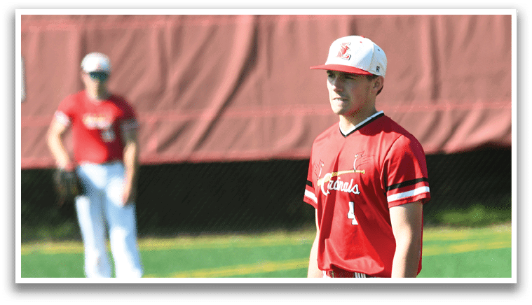 A baseball player wearing a red shirt and white pants. Description generated by AI