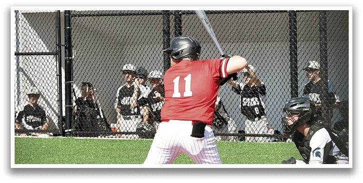 A baseball player in a red shirt is swinging a bat. Description generated by AI