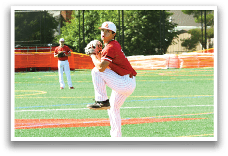A baseball player in a red shirt is pitching a ball. Description generated by AI