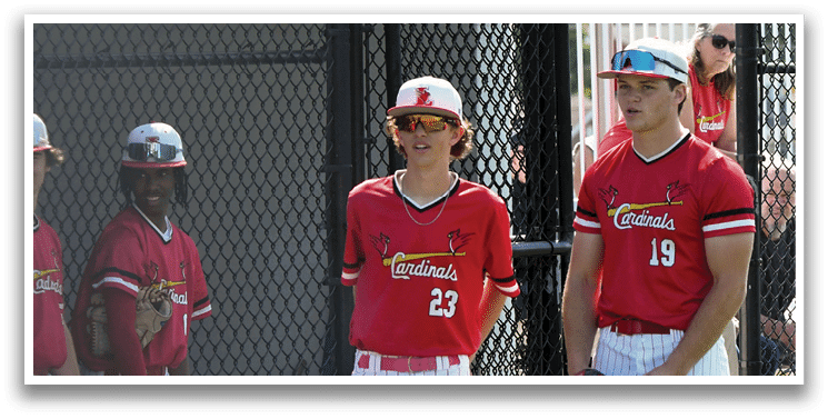 A group of young men wearing red and white baseball uniforms. Description generated by AI