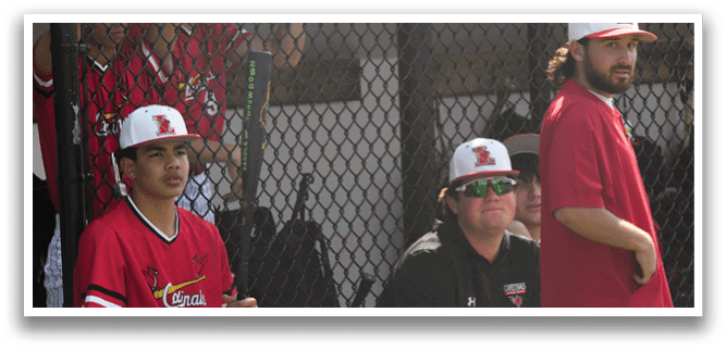A group of baseball players sitting on a bench. Description generated by AI