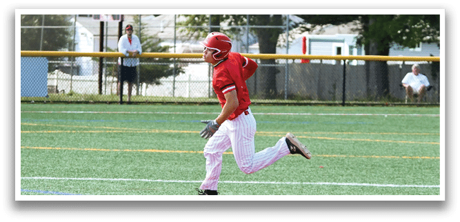A baseball player running to a base. Description generated by AI