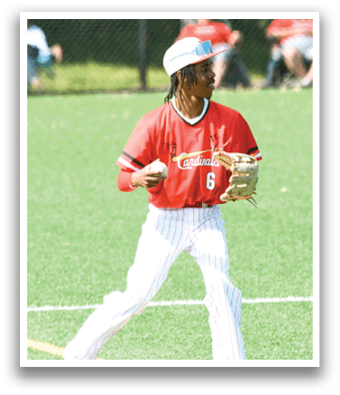 A baseball player wearing a red and white shirt and holding a baseball. Description generated by AI