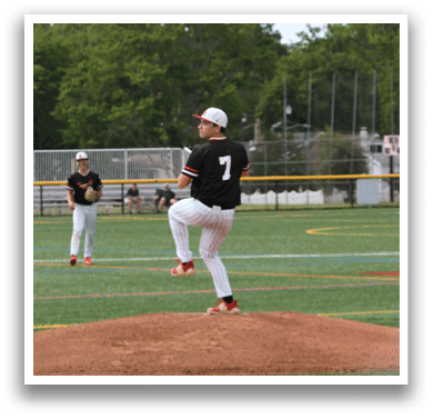 A baseball player is standing on the pitcher's mound. Description generated by AI