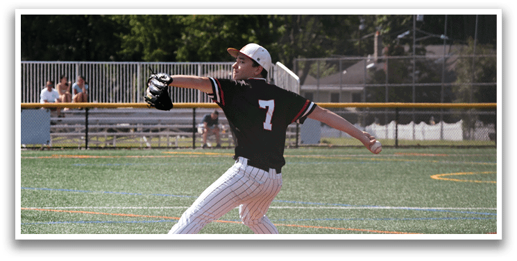A baseball player in a black and white uniform is pitching a ball. Description generated by AI