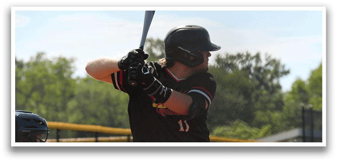 A baseball player is holding a bat and getting ready to swing. Description generated by AI