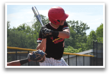 A baseball player in a black and red uniform is swinging a bat. Description generated by AI