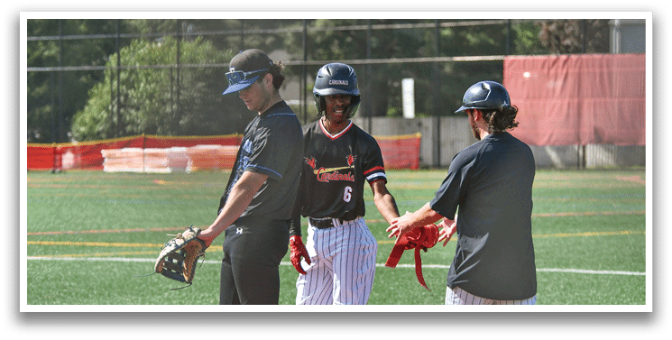Three baseball players on a field. Description generated by AI