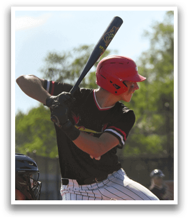A baseball player in a black and red shirt is swinging a bat. Description generated by AI
