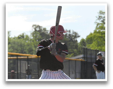 A baseball player holding a bat. Description generated by AI