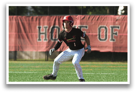 A baseball player wearing a red helmet and black shirt. Description generated by AI