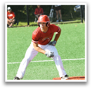 A baseball player in a red shirt and white pants is standing on a field. Description generated by AI