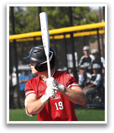 A baseball player holding a bat. Description generated by AI