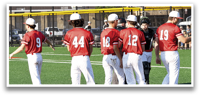 A group of baseball players wearing red shirts and white pants. Description generated by AI