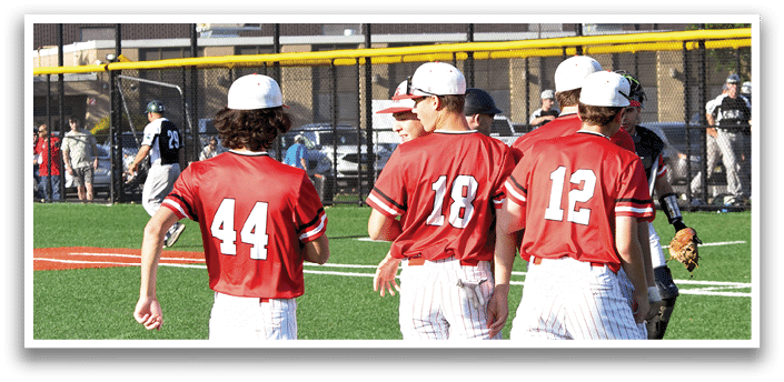 A group of baseball players wearing red and white uniforms. Description generated by AI