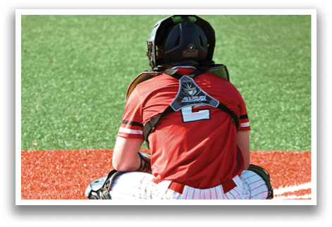 A baseball player wearing a red shirt and black helmet. Description generated by AI