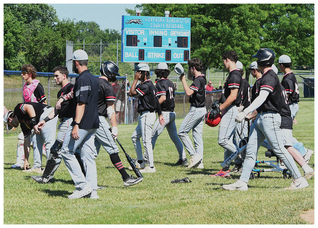 A baseball player in a black shirt and red helmet is swinging a bat. Description generated by AI
