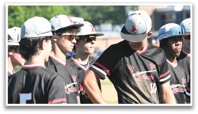 A group of baseball players wearing red and white uniforms. Description generated by AI