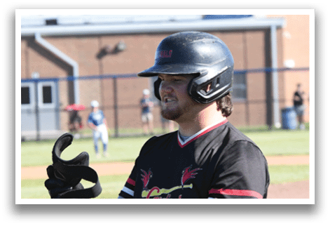A baseball player wearing a red shirt and black helmet. Description generated by AI