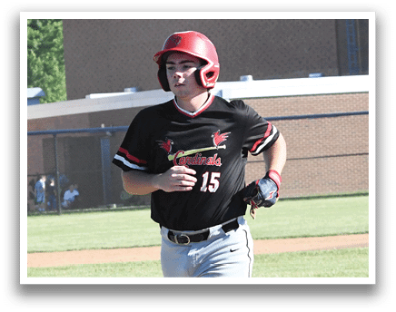 A baseball player in a red shirt and helmet holding a bat. Description generated by AI